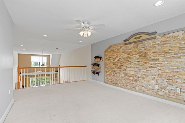 unfurnished room with ceiling fan and carpet flooring