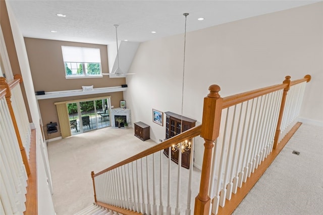 staircase with carpet floors and vaulted ceiling