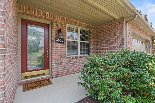 entrance to property featuring a garage and a porch