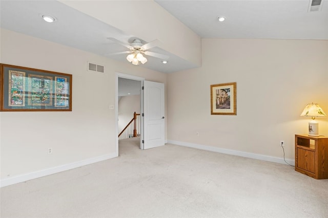 unfurnished bedroom with ceiling fan, light carpet, and vaulted ceiling