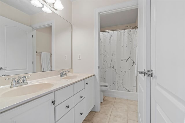 bathroom featuring vanity, tile patterned flooring, toilet, and curtained shower