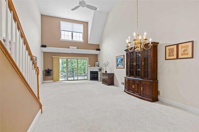 living room featuring ceiling fan with notable chandelier, light carpet, and high vaulted ceiling