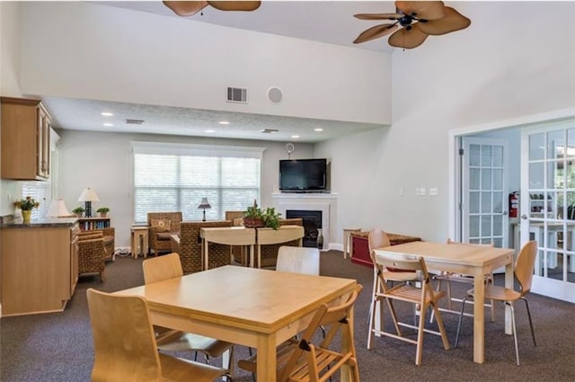 carpeted dining room with ceiling fan