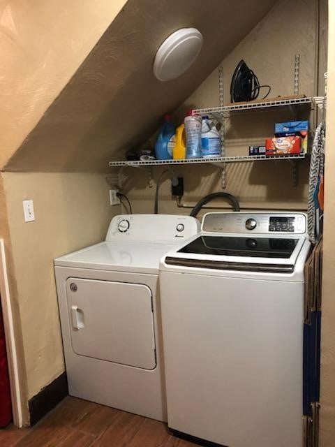 clothes washing area featuring hardwood / wood-style floors and washing machine and dryer