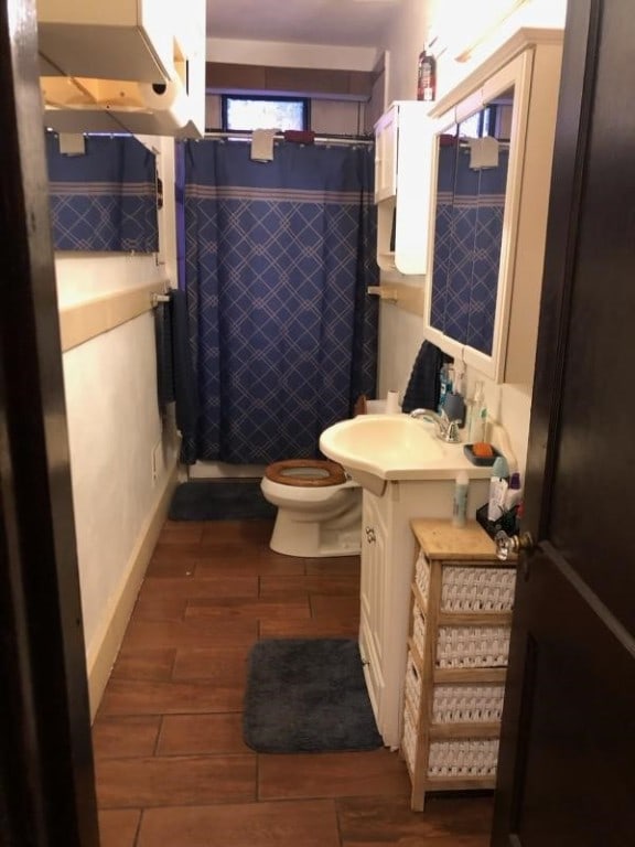 bathroom featuring vanity, toilet, a shower with curtain, and hardwood / wood-style flooring