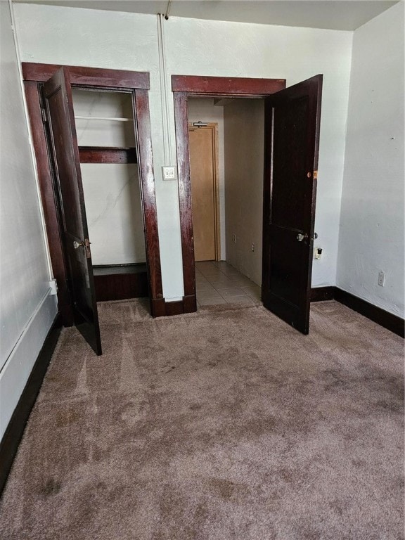 unfurnished bedroom featuring a closet and carpet floors