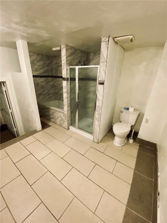 bathroom with independent shower and bath, toilet, and tile patterned flooring