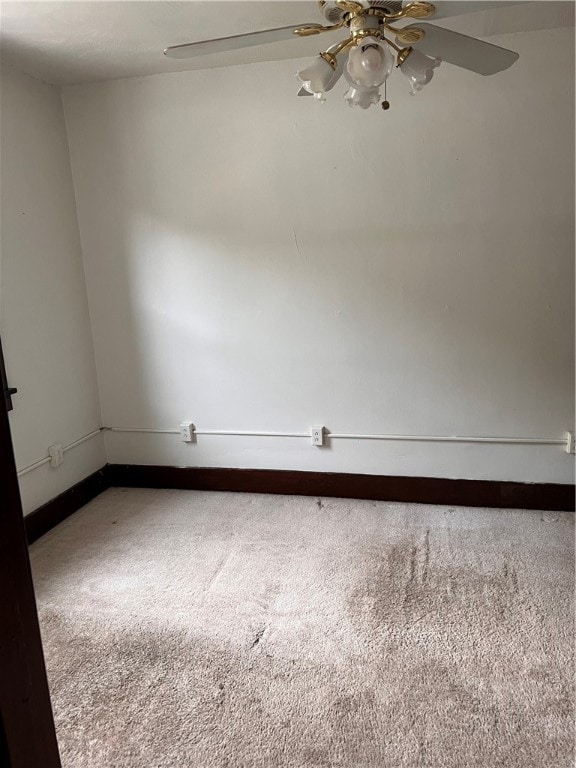 empty room featuring carpet flooring and ceiling fan