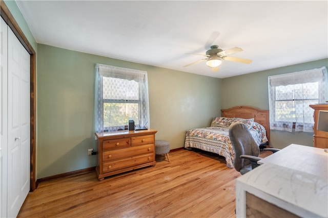 bedroom featuring multiple windows, ceiling fan, a closet, and light hardwood / wood-style floors