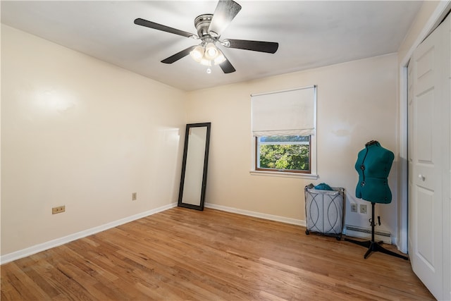 unfurnished bedroom with light wood-type flooring, ceiling fan, a closet, and baseboard heating