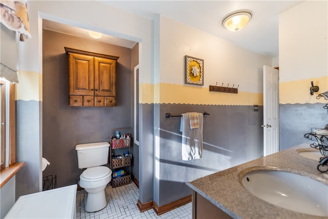 bathroom featuring vanity, toilet, and tile patterned floors