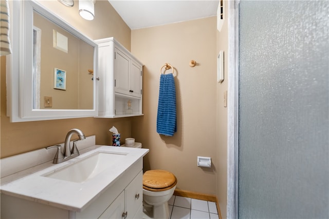 bathroom with tile patterned flooring, vanity, and toilet