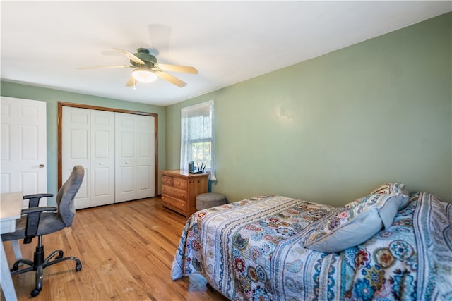 bedroom featuring a closet, light hardwood / wood-style floors, and ceiling fan