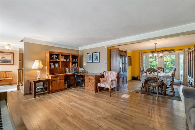 living room with a chandelier and light hardwood / wood-style floors