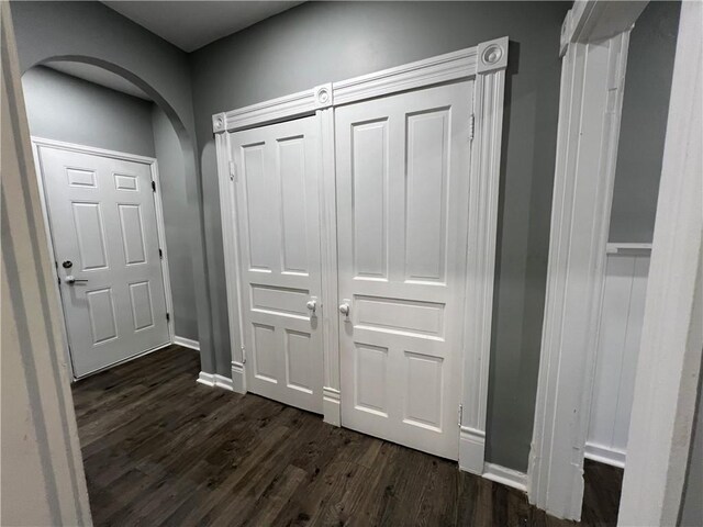 hallway with dark hardwood / wood-style flooring