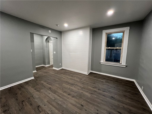 spare room featuring dark wood-type flooring