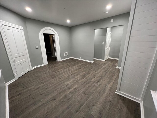 unfurnished room featuring dark hardwood / wood-style flooring