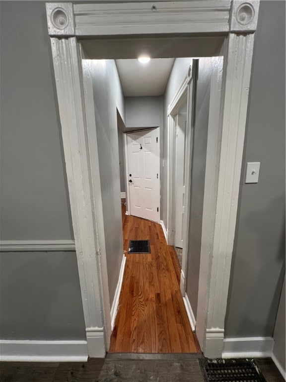 corridor with dark wood-type flooring