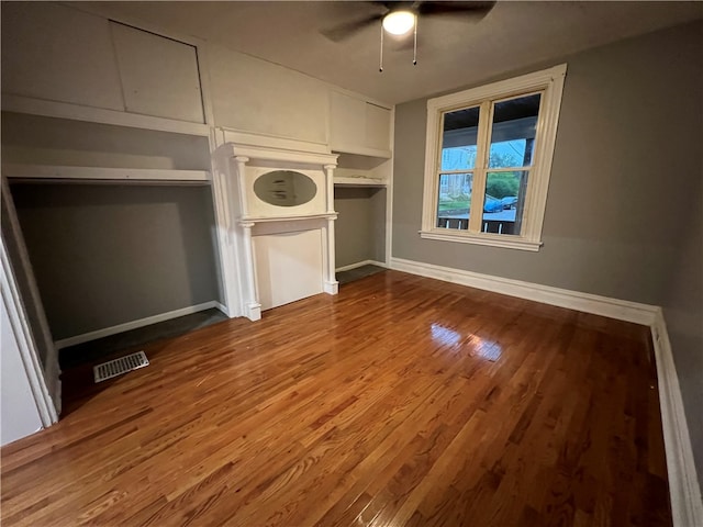 unfurnished bedroom featuring ceiling fan, hardwood / wood-style flooring, and a closet