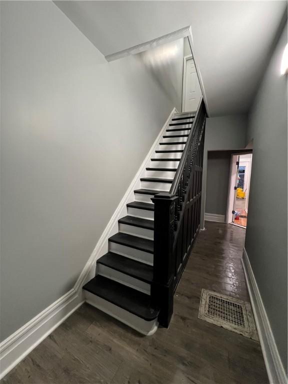 stairway with wood-type flooring