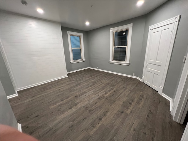 unfurnished room with dark hardwood / wood-style floors