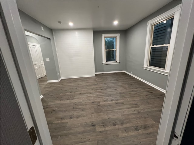 spare room with dark wood-type flooring