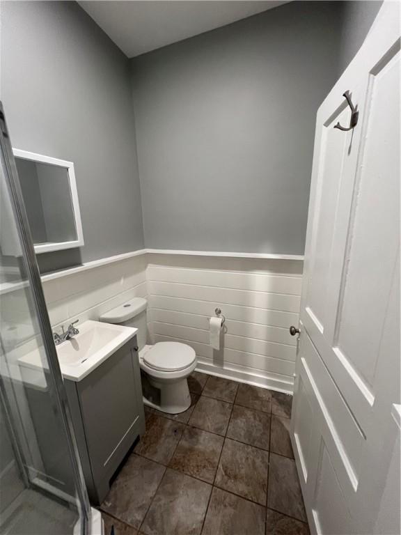 bathroom with vanity, tile patterned flooring, and toilet