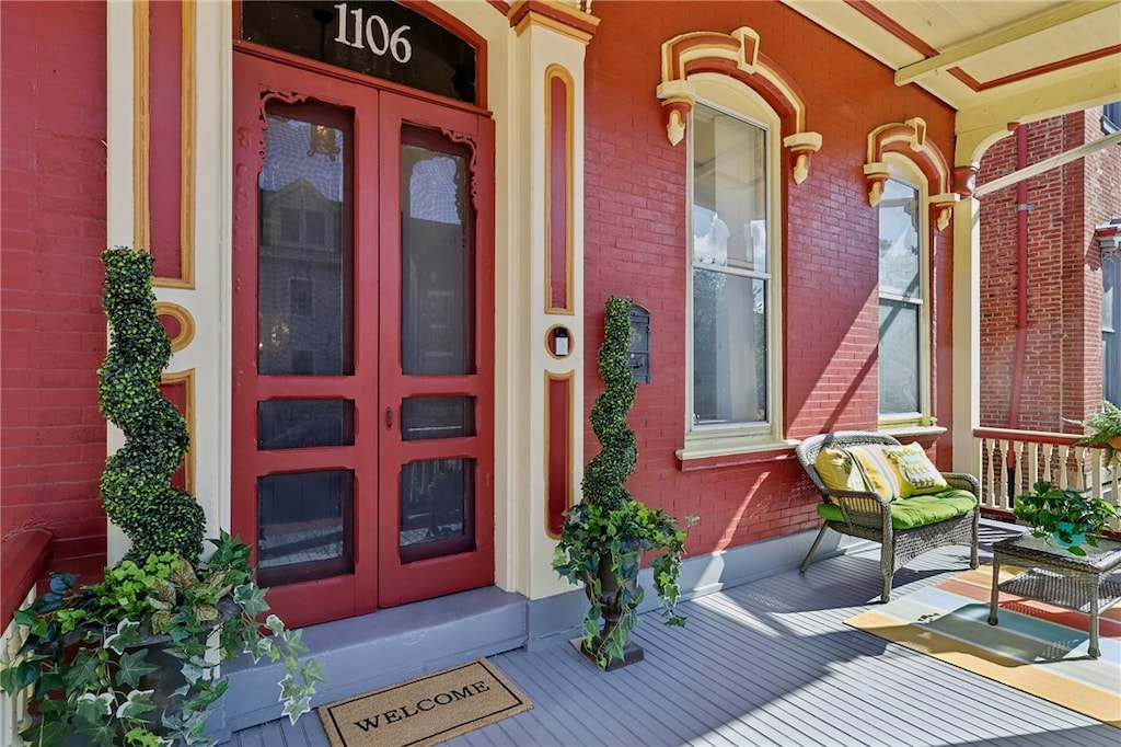 view of exterior entry featuring covered porch