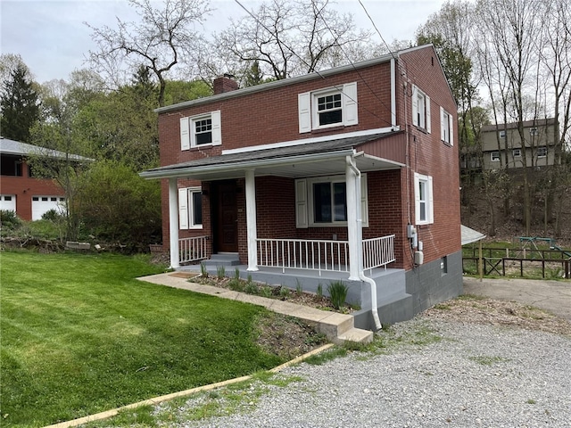 view of front of house featuring a front lawn and covered porch