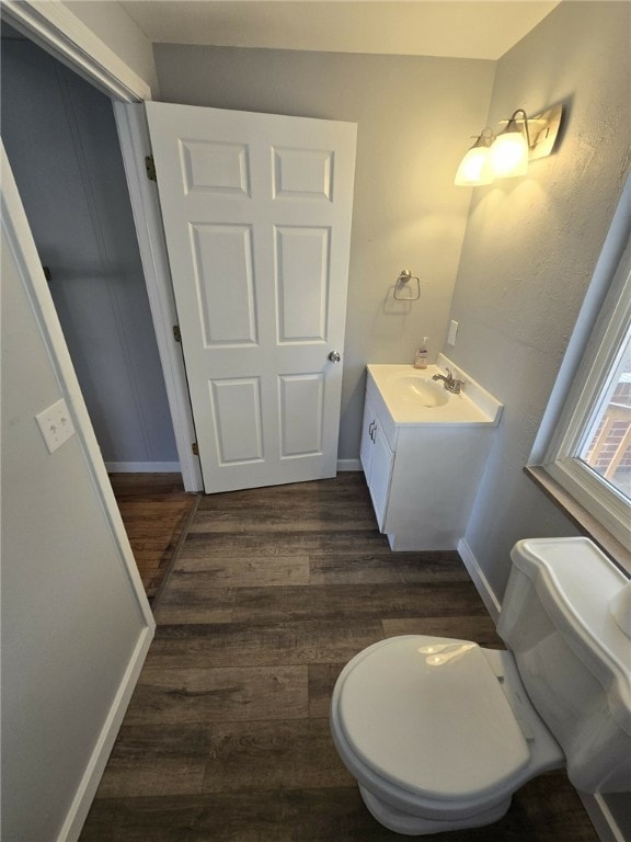 bathroom featuring hardwood / wood-style floors, vanity, and toilet