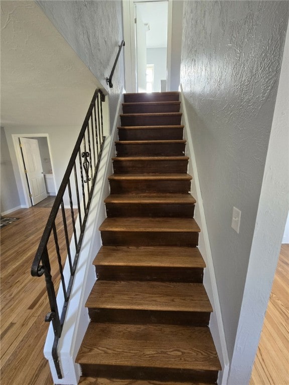 stairway with wood-type flooring