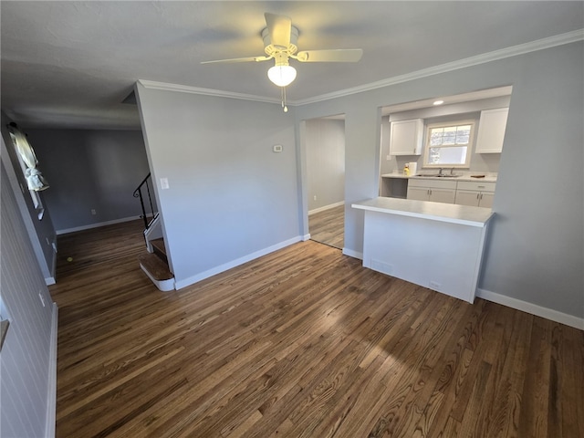 kitchen featuring ceiling fan, dark wood-type flooring, sink, crown molding, and white cabinetry