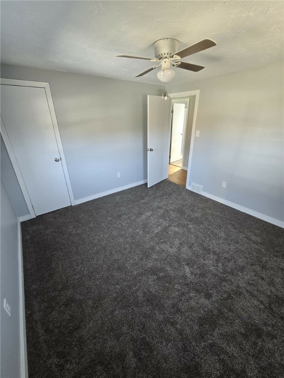 carpeted empty room with ceiling fan