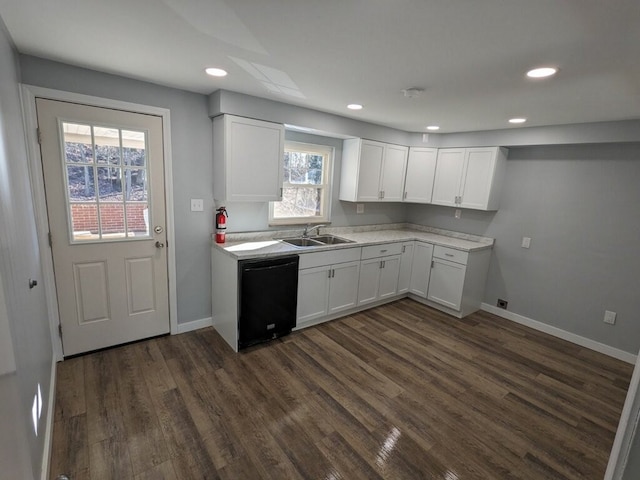 kitchen with dishwasher, dark hardwood / wood-style floors, sink, and white cabinetry