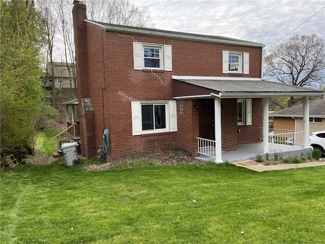 view of front of house with a porch and a front yard