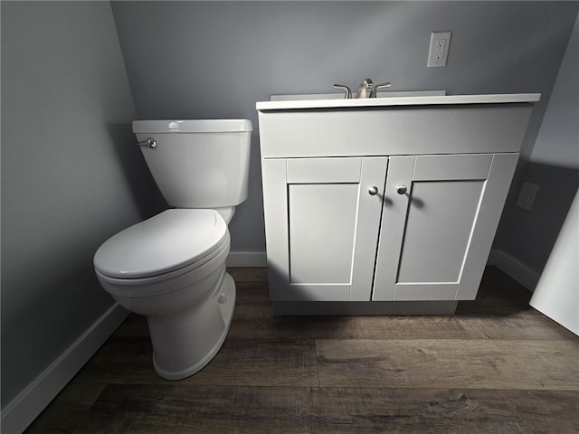 bathroom featuring vanity, toilet, and hardwood / wood-style flooring