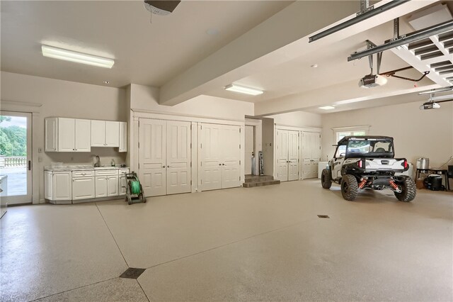 garage with a garage door opener and sink