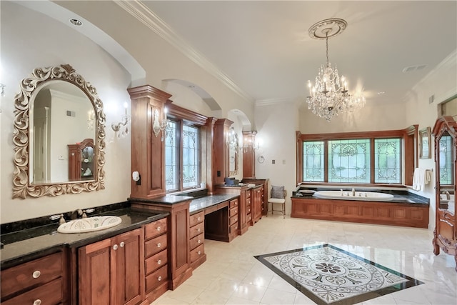 bathroom with a bathtub, an inviting chandelier, ornate columns, crown molding, and vanity