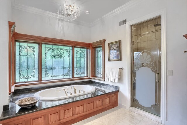 bathroom with ornamental molding, an inviting chandelier, and independent shower and bath