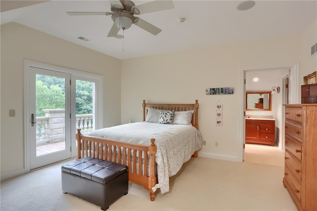 bedroom featuring light carpet, access to exterior, connected bathroom, and ceiling fan