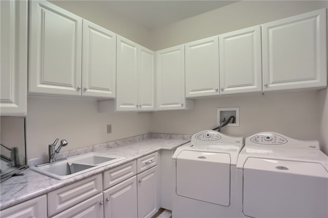 laundry room with cabinets, sink, and washing machine and clothes dryer