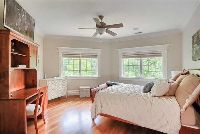 bedroom featuring crown molding, ceiling fan, and wood-type flooring