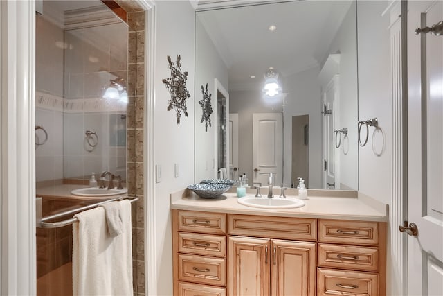 bathroom with vanity, crown molding, and tiled shower