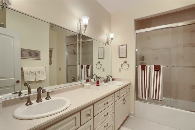 bathroom featuring combined bath / shower with glass door, tile patterned flooring, and vanity