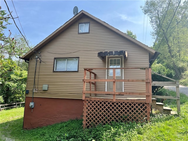 rear view of house with a wooden deck