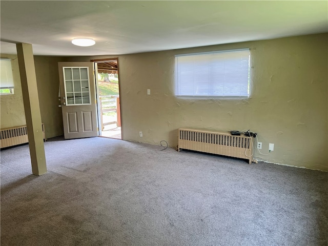 carpeted empty room with radiator