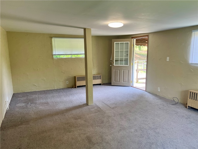 spare room with carpet flooring and radiator