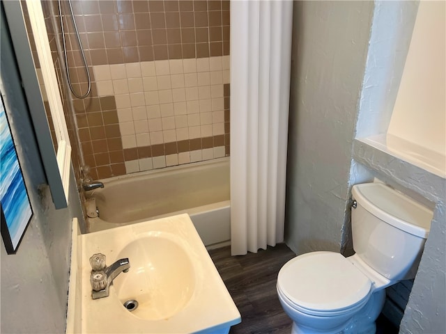 full bathroom featuring sink, shower / bath combination with curtain, wood-type flooring, and toilet