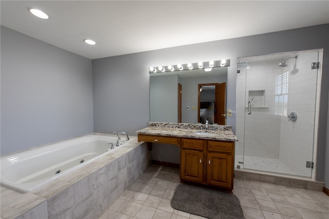 bathroom with shower with separate bathtub and vanity