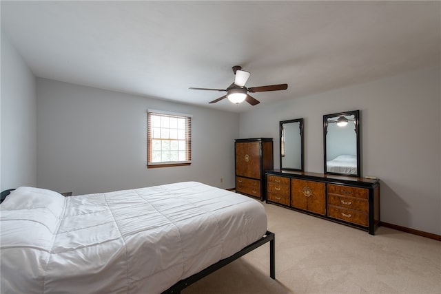 bedroom with light carpet and ceiling fan